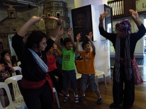 Levi Azarcon and Mannex Siapno demonstrate pangalay postures and gestures  while boys enthusiastically imitate them.